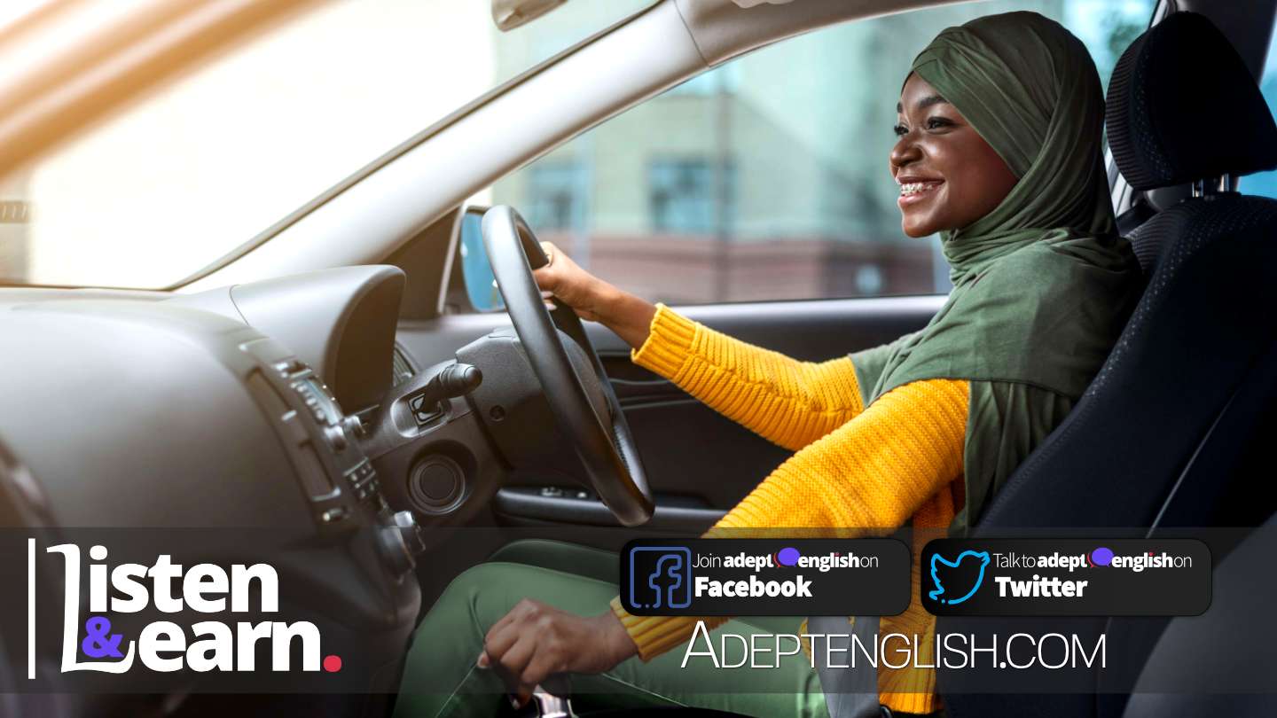 Portrait photograph of a happy African Muslim woman in headscarf in new car, part of this English conversation listening practice lesson.