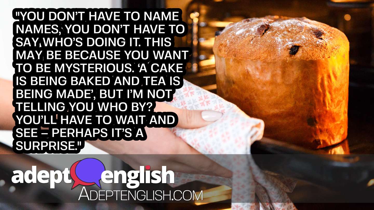 A photograph of a cake being taken from an oven. ESL English grammar how to use verbs in past and present voice.