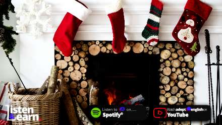Christmas stockings hung over a traditional fireplace. Improve your spoken English by listening to our Christmas podcast which will give you insight into how Christmas is celebrated in Britain.