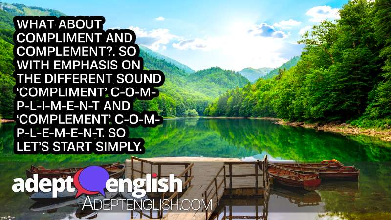 A stunning picture of a lake in the mountains, with wooden boats on the water in the foreground and mountains and forest in the distance. Used as an article image for the article Learn English, Speak Fluently And Understand Everything You Hear: Homophones Article Image