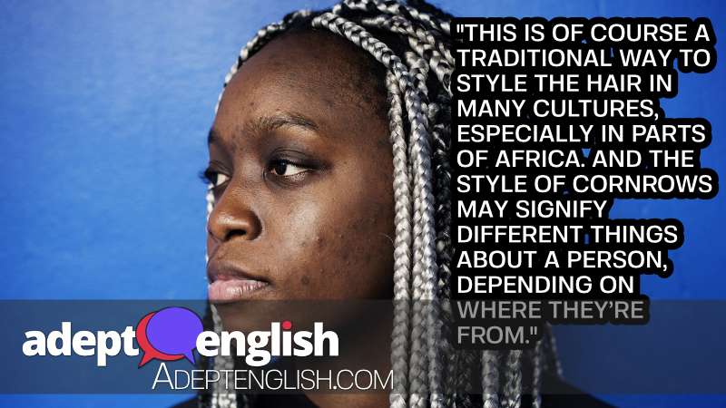 A portrait photograph of a black woman with cornrow hair.