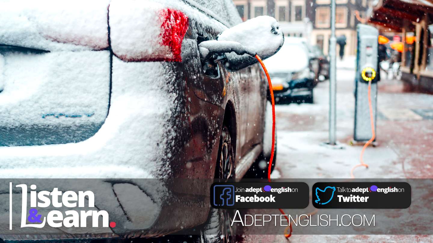 A photograph of an electric car on charge on a main street covered in snow on a very cold day. Used as cover art for the how to learn English lesson talking about electric cars in the UK.